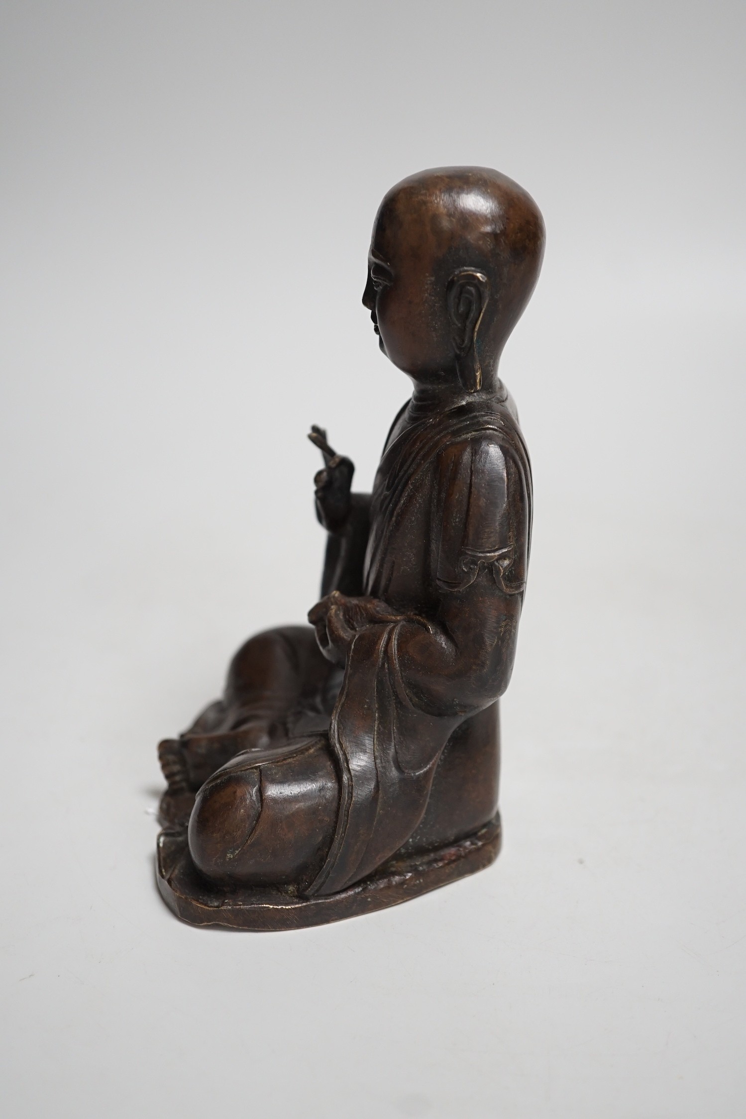 A Nepalese bronze figure of a seated immortal, probably 17th / 18th century, 16cm